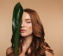 beauty portrait sensual ginger woman with long hair posing with green leaf 90x80
