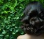 luxurious womens glossy hollywood curls against green background min 90x80